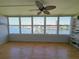 Sunlit living room with large windows offering serene waterfront views, complete with wood flooring and custom shelving at 1893 Shore S Dr # 208, South Pasadena, FL 33707