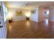 Spacious living room featuring wood floors, bright windows, and artwork at 1893 Shore S Dr # 208, South Pasadena, FL 33707