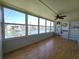 Sunroom featuring shelves and windows with views of the waterfront and neighborhood at 1893 Shore S Dr # 208, South Pasadena, FL 33707