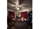 Bedroom with a ceiling fan, two windows and dark blue patterned carpet at 4108 W Euclid Ave, Tampa, FL 33629