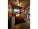 Cozy dining room with wood paneling, a table with chairs, and a ceiling fan at 4108 W Euclid Ave, Tampa, FL 33629