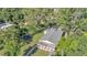 Aerial view featuring a fenced yard, large mature trees, basketball hoop, and a trampoline at 4818 Huron St, Zephyrhills, FL 33541