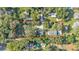 Aerial view of a property boundary in a neighborhood with scattered houses and lots of tree coverage at 4818 Huron St, Zephyrhills, FL 33541