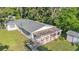 A charming single-story home featuring a cozy front porch with white railings and an American flag at 4818 Huron St, Zephyrhills, FL 33541