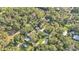 Aerial view featuring a pool, large yard and surrounding trees highlighting the home's private location at 4818 Huron St, Zephyrhills, FL 33541