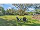 Spacious backyard featuring lush greenery and large trees, perfect for outdoor relaxation and entertaining at 4818 Huron St, Zephyrhills, FL 33541