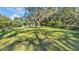 Expansive backyard shaded by mature trees, offering ample space for recreation and leisure at 4818 Huron St, Zephyrhills, FL 33541