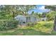Backyard view with a fenced area, some shrubbery, and a glimpse of a swing at 4818 Huron St, Zephyrhills, FL 33541