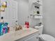Bright bathroom featuring a stylish sink, modern toilet, and decorative accents at 4818 Huron St, Zephyrhills, FL 33541