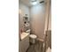 Half bath with modern vanity, wood look flooring and decor at 4818 Huron St, Zephyrhills, FL 33541