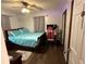 This bedroom has wood floors, a ceiling fan and window for natural light at 4818 Huron St, Zephyrhills, FL 33541