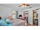 Well-lit bedroom features a bed, desk area, and ample storage space at 4818 Huron St, Zephyrhills, FL 33541