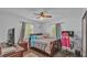 Inviting bedroom features a cozy bed, natural lighting, and a workspace at 4818 Huron St, Zephyrhills, FL 33541