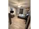 This bedroom has wood look tile flooring, a ceiling fan and closet for storage at 4818 Huron St, Zephyrhills, FL 33541