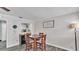 Charming dining area adjacent to the kitchen features stylish decor and wood-look flooring at 4818 Huron St, Zephyrhills, FL 33541
