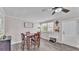 Bright dining room with wood floors, modern decor, and lots of natural light at 4818 Huron St, Zephyrhills, FL 33541