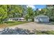 Spacious home with a large yard, detached garage, and well-maintained landscaping at 4818 Huron St, Zephyrhills, FL 33541