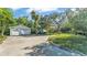 Charming home with lush landscaping, an RV, and a detached garage at 4818 Huron St, Zephyrhills, FL 33541