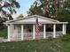 Charming single-story home featuring a welcoming front porch with white picket fence, perfect for enjoying the outdoors at 4818 Huron St, Zephyrhills, FL 33541