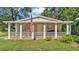 Charming home featuring a welcoming front porch adorned with an American flag at 4818 Huron St, Zephyrhills, FL 33541