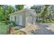 Detached two-car garage with a side entrance and driveway; note tree stump detail at 4818 Huron St, Zephyrhills, FL 33541