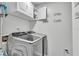 Laundry room features modern machines and storage cabinets for convenience at 4818 Huron St, Zephyrhills, FL 33541