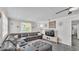Inviting living room featuring a comfortable sectional sofa, stylish decor, and a ceiling fan at 4818 Huron St, Zephyrhills, FL 33541