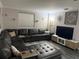 Cozy living room featuring a plush sectional sofa, stylish decor, and a modern entertainment center at 4818 Huron St, Zephyrhills, FL 33541