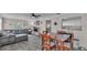 Open-concept living space with a large leather sectional sofa and adjacent dining area at 4818 Huron St, Zephyrhills, FL 33541