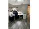 Home office featuring wood look tile flooring, a ceiling fan, and two desks at 4818 Huron St, Zephyrhills, FL 33541