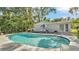 Backyard with a refreshing in-ground pool and outdoor dining set for entertaining at 4818 Huron St, Zephyrhills, FL 33541