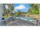 Inviting in-ground pool with dining area, perfect for entertaining friends and Gathering at 4818 Huron St, Zephyrhills, FL 33541