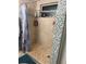 This shower features a decorative tile accent wall and tile flooring at 4818 Huron St, Zephyrhills, FL 33541