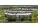 Aerial view of the condo community highlighting its layout, lake, greenery, and building exteriors at 5980 80Th N St # 408, St Petersburg, FL 33709