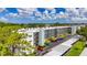 Aerial view of the building featuring manicured landscaping and parking at 5980 80Th N St # 408, St Petersburg, FL 33709