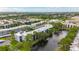 Aerial view of the community featuring condo buildings, lush greenery, lake, and convenient parking at 5980 80Th N St # 408, St Petersburg, FL 33709