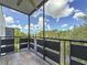 Balcony with tile floor overlooking trees and blue sky with white clouds at 5980 80Th N St # 408, St Petersburg, FL 33709