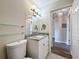 Bathroom featuring granite counters, updated fixtures, and a lovely mirror with sconces at 5980 80Th N St # 408, St Petersburg, FL 33709