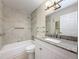 Updated bathroom featuring a shower/tub combo with modern fixtures and granite countertops at 5980 80Th N St # 408, St Petersburg, FL 33709
