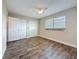 Clean and bright bedroom featuring stylish wood-look floors and ample closet space at 5980 80Th N St # 408, St Petersburg, FL 33709