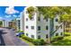 Exterior view of building with well-manicured landscaping and parking at 5980 80Th N St # 408, St Petersburg, FL 33709