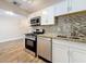 This kitchen features a gas range, stainless steel appliances, and granite countertops at 5980 80Th N St # 408, St Petersburg, FL 33709