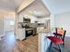 Bright kitchen with granite countertops, white cabinets, stainless steel appliances, and a breakfast bar at 5980 80Th N St # 408, St Petersburg, FL 33709