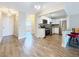 Open-concept kitchen with stainless steel appliances, white cabinets, and breakfast bar at 5980 80Th N St # 408, St Petersburg, FL 33709