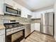 Updated kitchen featuring stainless steel appliances, mosaic backsplash and granite countertops at 5980 80Th N St # 408, St Petersburg, FL 33709