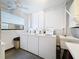 Laundry room featuring three machines, large window, and utility sink at 5980 80Th N St # 408, St Petersburg, FL 33709