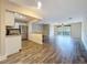 Bright living room featuring wood flooring, view to outdoor balcony, and a breakfast bar at 5980 80Th N St # 408, St Petersburg, FL 33709