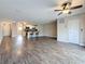 Spacious living room area featuring sleek wood-look flooring and a ceiling fan at 5980 80Th N St # 408, St Petersburg, FL 33709