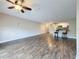 Living room with wood floors, ceiling fan and breakfast bar area peering into the kitchen at 5980 80Th N St # 408, St Petersburg, FL 33709