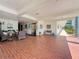 Welcoming lobby area featuring red brick floors, comfortable seating, and an elevator at 5980 80Th N St # 408, St Petersburg, FL 33709